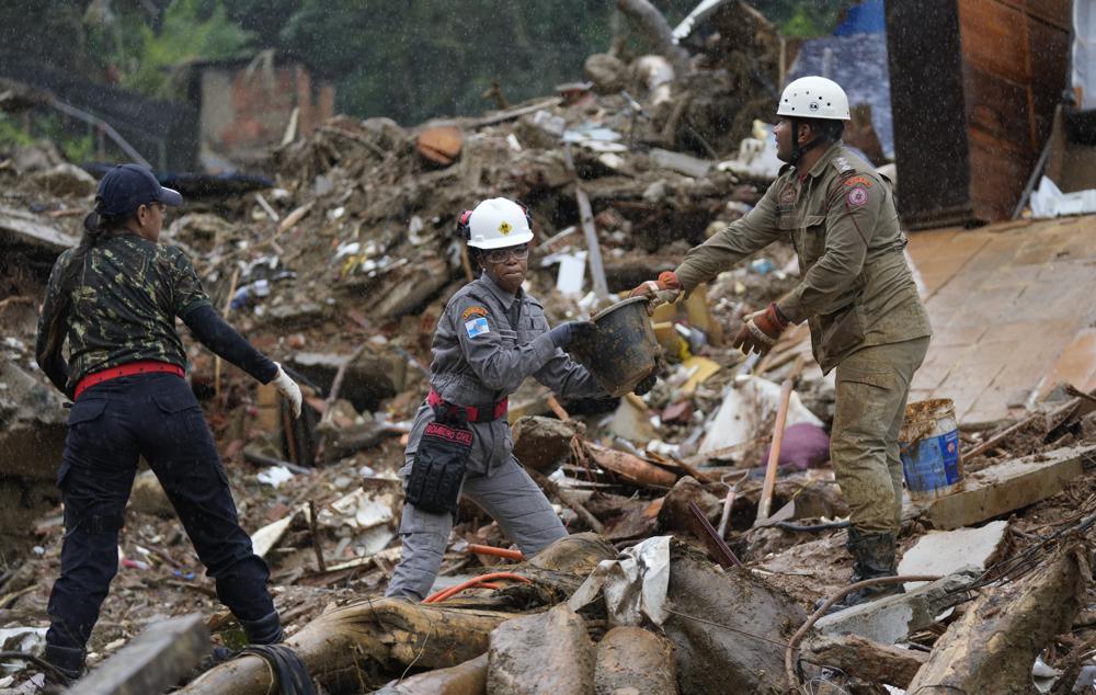 Rescue workers search for victims on the third day after deadly mudslides in Petropolis, Brazil, Friday, Feb. 18, 2022. (AP Photo/Silvia Izquierdo)