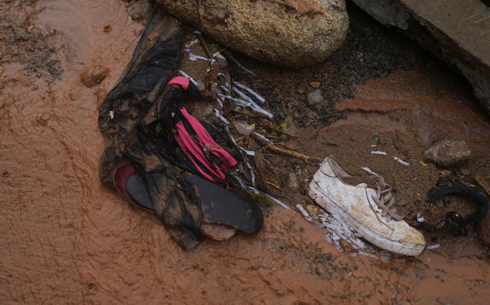 Shoes lay amid the debris of homes destroyed by fatal mudslides on the third day of rescue efforts in Petropolis, Brazil, Friday, Feb. 18, 2022. (AP Photo/Silvia Izquierdo)