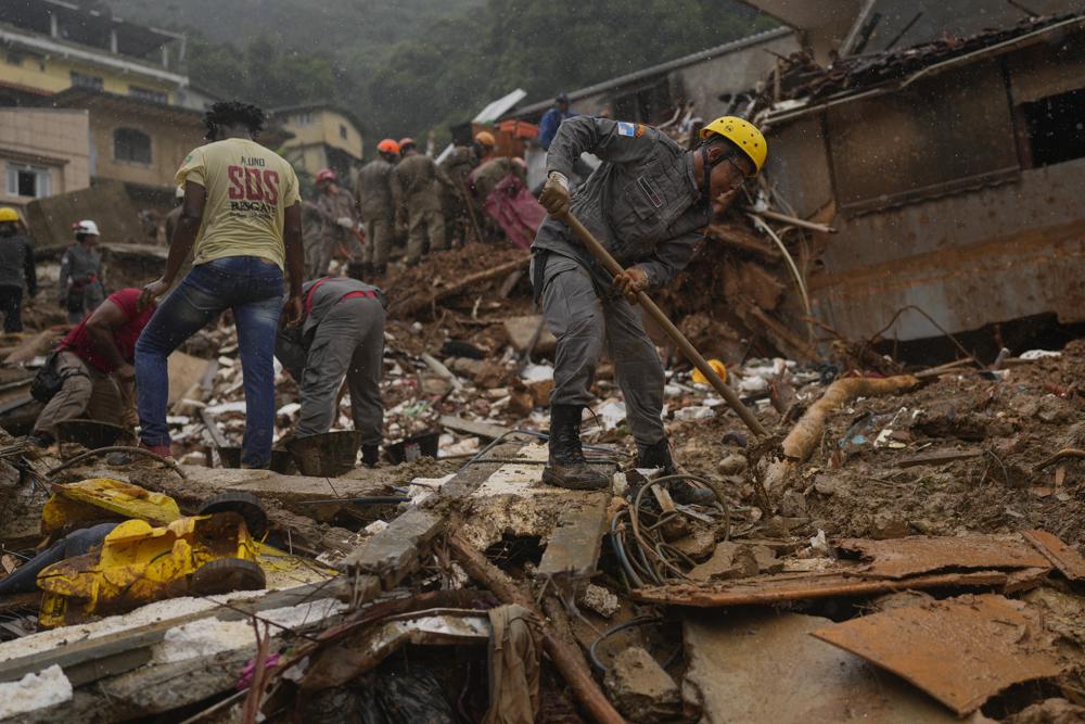 Rescue workers search for victims three days after deadly mudslides in Petropolis, Brazil, Friday, Feb. 18, 2022. (AP Photo/Silvia Izquierdo)